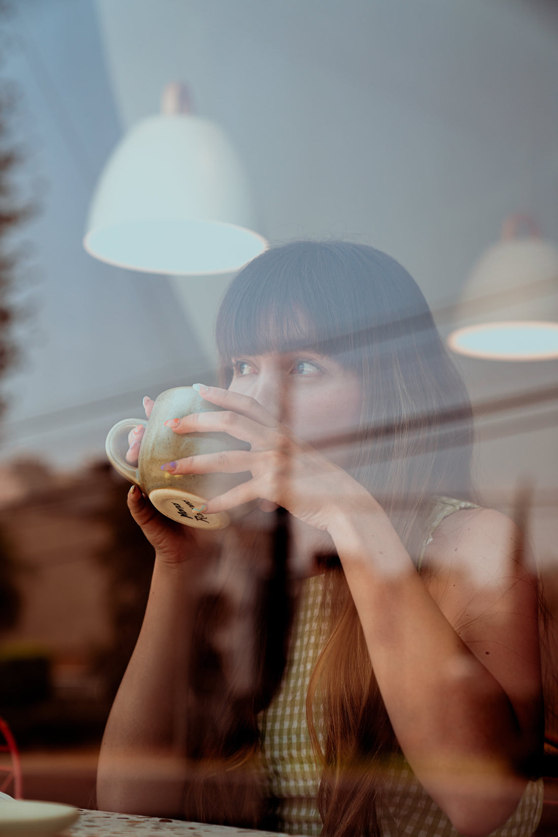 woman drinking coffee by the window and this is for the post does coffee make you lose weight