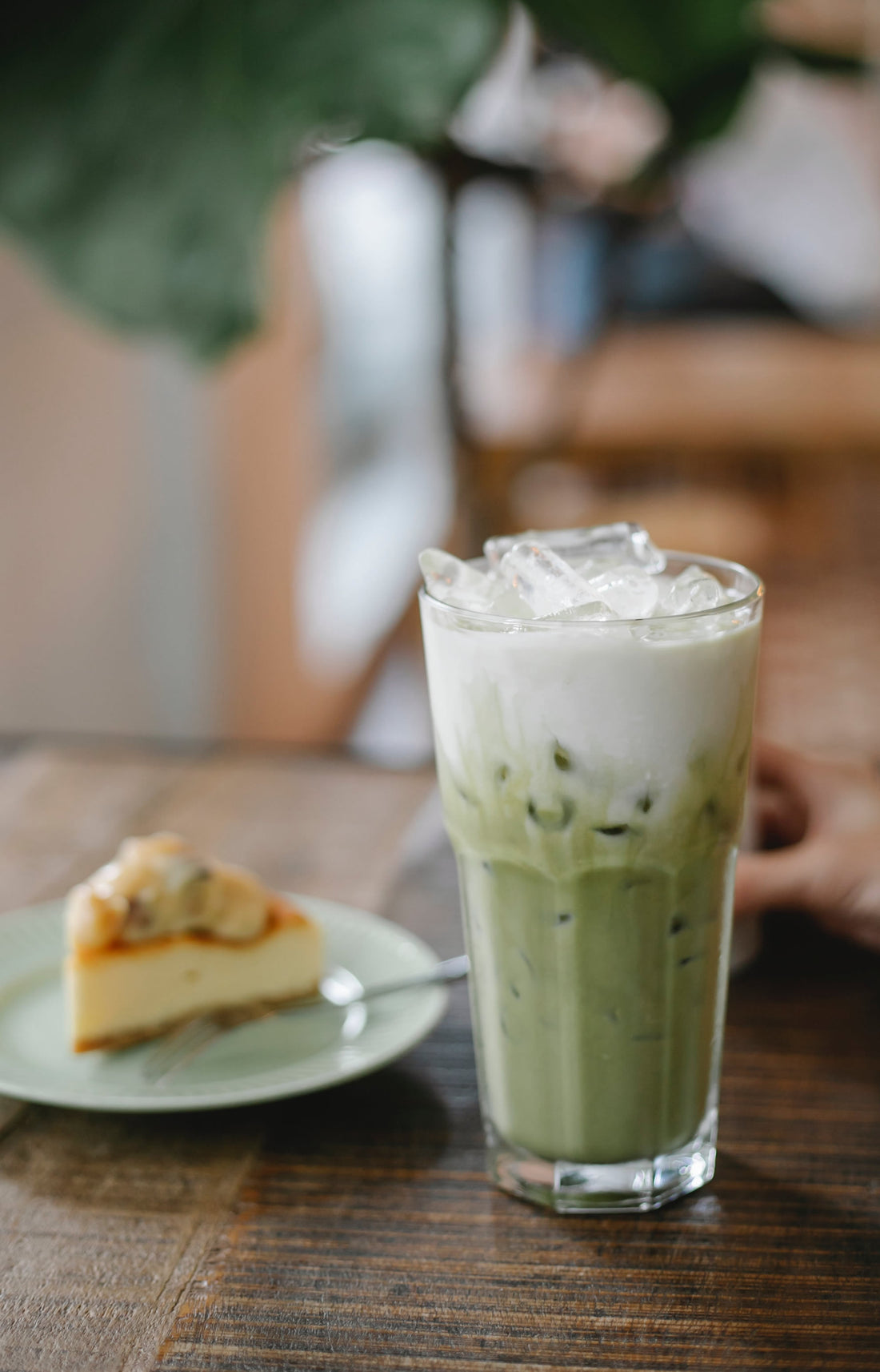 A glass of cold brew coffee and a pie on the side.