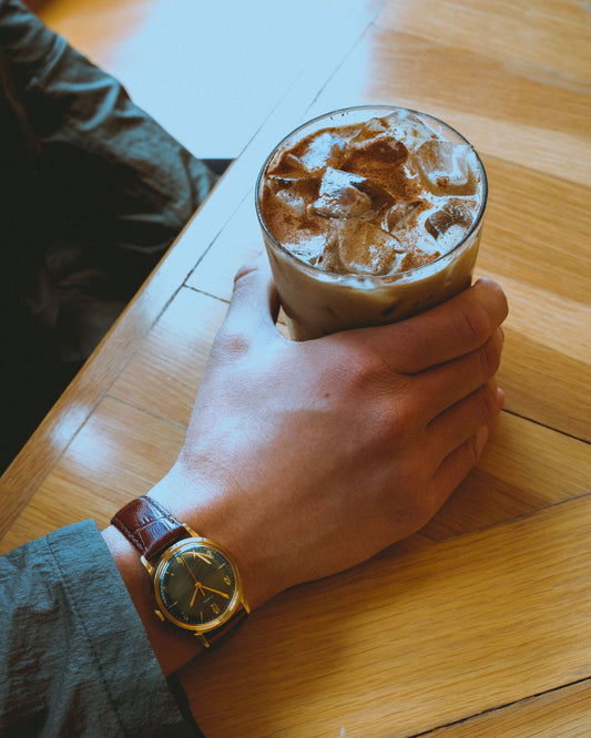 man holding iced coffee for post iced coffee benefits